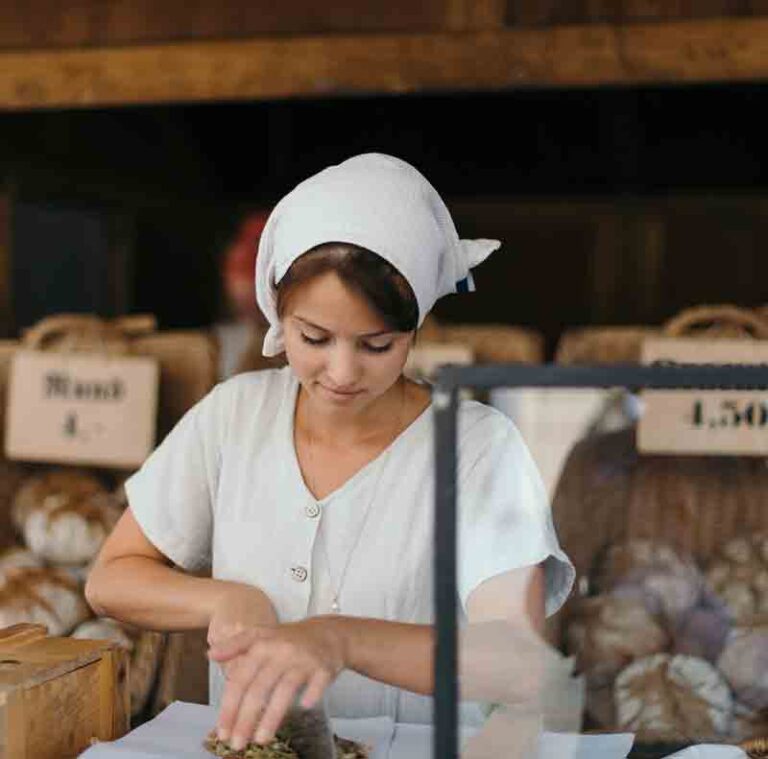 Young Woman Chef Serving Fresh Salad at Kitchen